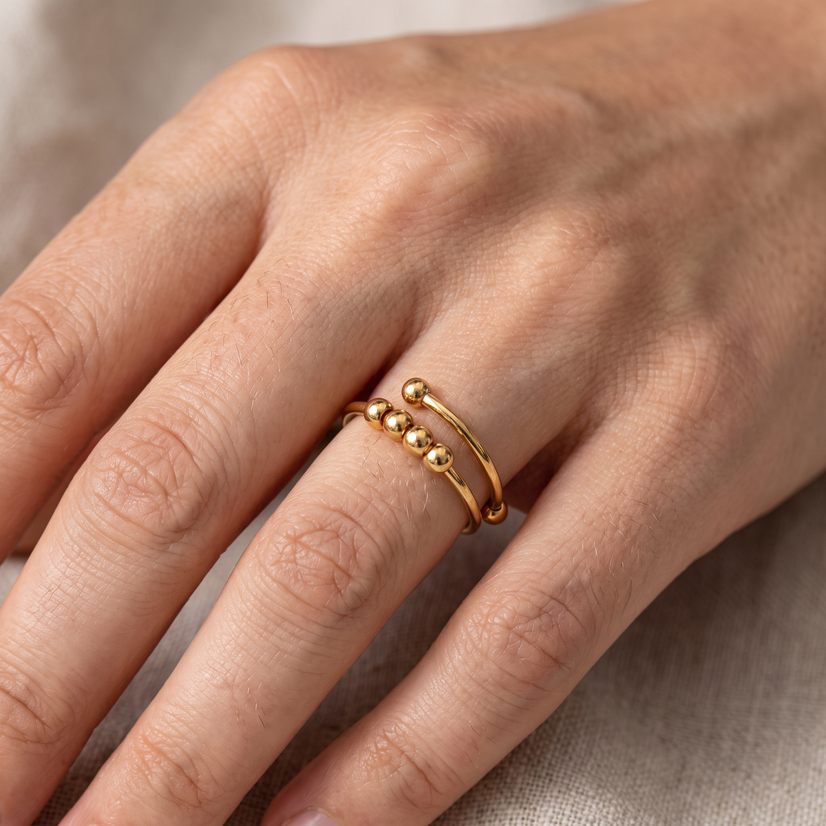 Maelis – Anillo antiestrés con perlas giratorias